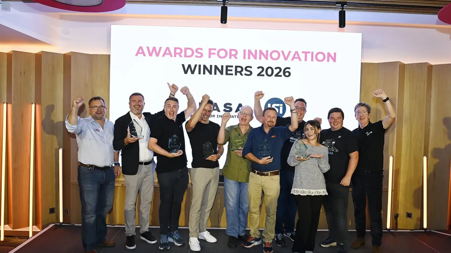 Group of people under banner announcing Award winners