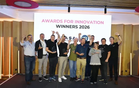 Group of people under banner announcing Award winners