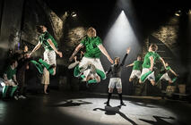 Photograph from The Beautiful Game - lighting design by Christopher Mould