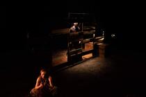 Photograph from We Like It Here - lighting design by Alan Mooney