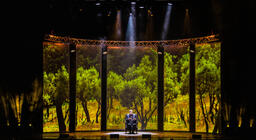 Photograph from Stephen Fry - Mythos Tour, A Trilogy Of A Shows - lighting design by Archer